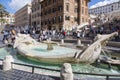 Tourists at the fountain of Barkaccha in the form of a boat in the Plaza of Spain in Rome