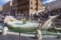 Tourists at the fountain of Barkaccha in the form of a boat in the Plaza of Spain in Rome