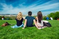 Tourists friend sitting on the green grass with beautiful view to Vienna panorama