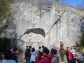 Tourists in front of the LÃ¶wendenkmal stone, which is the famous Lion of Lucerne