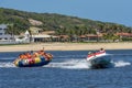 Tourists on a fun boat at Barra de Cunhau on Brazil