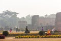 Tourists in the gardens around the misty ruins of the ancient Adina Masjid mosque in the