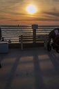 Tourists gather in the shadows of a sunseta at La Jolla Beach in San Diego