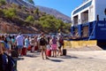 Tourists go to the Blue Star sea ferry on Symi Island