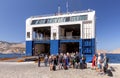 Tourists go to the Blue Star sea ferry on Symi Island