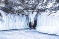 Tourists in a grotto on the winter coast of Lake Baikal.