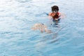 Tourists guide showing a turtle in the sea