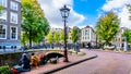 Tourists hanging at the Blauwburgwal canal in Amsterdam, Holland