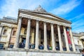 Tourists hanging out at the entrance of National Gallery museum in Trafalgar Square in London, England, UK Royalty Free Stock Photo