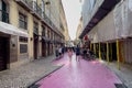 Tourists hanging out on the pink street in Lisbon