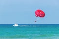 Tourists have fun, parachuting behind a boat, parasailing.