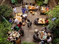 Tourists having dinner at a garden restaurant