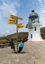 Tourists having fun at Cape Reinga lighthouse in New Zealand
