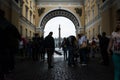 Tourists hiding from the rain under the arch of the General Staff Building, St. Petersburg, Russia Royalty Free Stock Photo