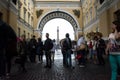 Tourists hiding from the rain under the arch of the General Staff Building, St. Petersburg, Russia Royalty Free Stock Photo