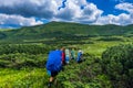 Tourists hike on rocky mounts