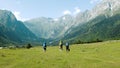 Tourists hikers with large backpacks are walking in the mountains in a hike against the backdrop of a beautiful