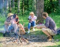 Tourists hikers sit on log relaxing waiting picnic snack. Company having hike picnic nature background. Picnic with Royalty Free Stock Photo