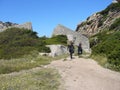 Tourists hikers walking in green meadow, bright spring morning, Sardinia, Italy