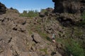 Tourists hiking among rock formations in Dimmuborgir in Iceland Royalty Free Stock Photo