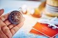 Tourists hold a compass and locate a place on a world map Royalty Free Stock Photo