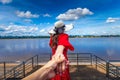 Tourists hold hands while looking at the Mekong River view in Nakhon Phanom Province, Thailand