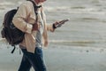 Tourists hold maps and walking on the beach to find attractions, restaurants or hotels. backpacker and travel concept