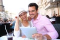 Tourists holding tablet at cafe in Rome