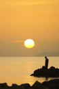 Tourists on holiday in the famous resort town of Bodrum spend time fishing at sunset. Royalty Free Stock Photo