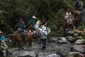 Tourists on horse back crossing a river in the jungle Royalty Free Stock Photo