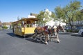 Tourists in a horse drawn wooden cart enjoy visiting the danish city of Solvang in California