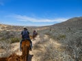 Tourists horseback riding on the beach in Cabo San Lucas, Baja California, Mexico, 2019