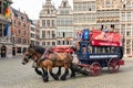 Tourists in a horsecar downtown in the medieval city Antwerp