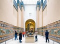 Tourists inside Pergamon museum looking on Lion mosaic from Ishtar Gate from Ancient Babylon. Berlin, Germany