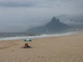 Tourists in the Ipanema Beach in a cloudy day in Rio de Janeiro, Brazil. Royalty Free Stock Photo