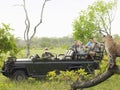 Tourists In Jeep Looking At Cheetah On Log Royalty Free Stock Photo