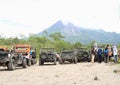 Tourists and jeeps on viewpoint to Merapi volcano