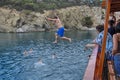 Tourists jump into the water