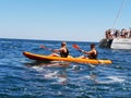 Tourists kayaking along the coast of Lagos, Portugal