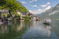 Tourists lake cruise boat on Hallstattersee by the World Heritage lakeside town in the Alps, Hallstatt, Salzkammergut, Austria Royalty Free Stock Photo