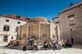 Tourists at the Large Onofrio Fountain located at Stradun street in the old town of Dubrovnik Royalty Free Stock Photo