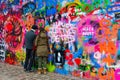 Tourists leave inscription on famous John Lennon Wall in Prague, Czech Republic