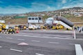 Tourists leave a Jet2 plane while crews arrive to offload luggage and to fuel and service the plane ready for its next flight.