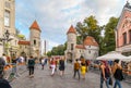 Tourists leave the medieval Old Town of Tallinn Estonia through the picturesque Viru Gate Royalty Free Stock Photo