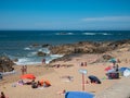 Tourists lie in the sun on the beach in Foz do Douro, Porto, Portugal