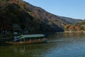 Tourists like to take a boat ride to see the changing colors of Arashiyama during the fall foliage season. Royalty Free Stock Photo