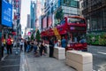 Tourists lining up to board a red double decker sightseeing bus in Times Square Manhattan New York Royalty Free Stock Photo