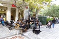 Tourists listening to a teenagers music band