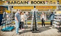 Tourists on Llandudno pier browsing books and CDs at an outdoor bargain book stall