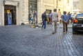 Tourists and local Italians pass by two panhandling street dogs in Trastevere district of Rome Italy Royalty Free Stock Photo